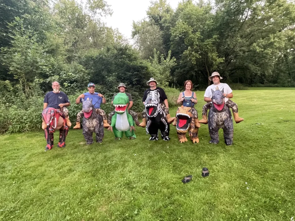 Campers lined up on the lawn with colorful hobby horses